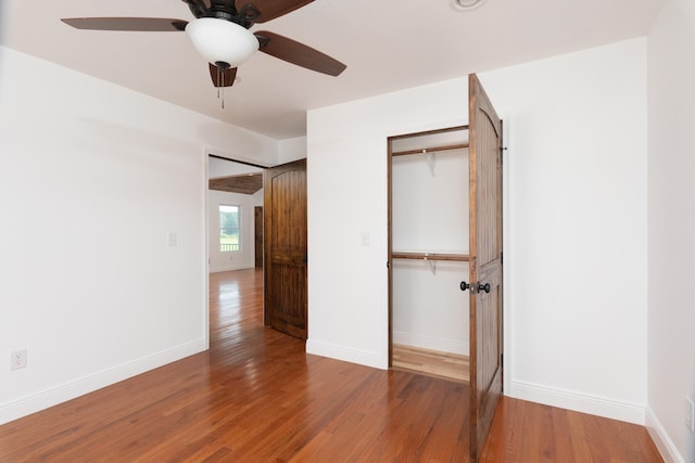 unfurnished bedroom featuring a closet, ceiling fan, and hardwood / wood-style flooring