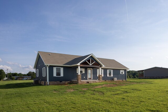 view of front of property with a front lawn and central air condition unit