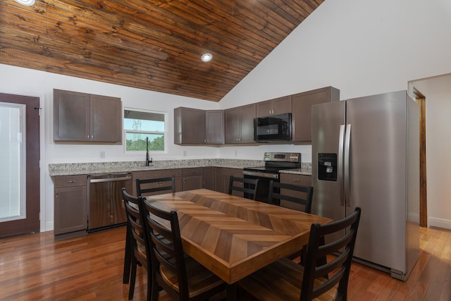 kitchen with high vaulted ceiling, stainless steel appliances, dark brown cabinetry, and dark hardwood / wood-style flooring