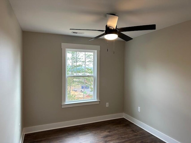 spare room featuring ceiling fan and dark hardwood / wood-style flooring