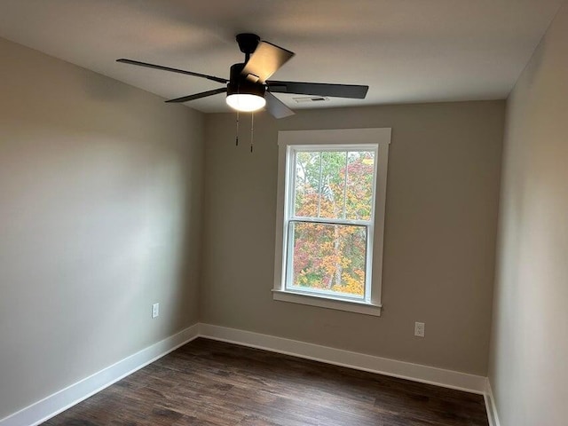 spare room featuring ceiling fan and dark hardwood / wood-style flooring