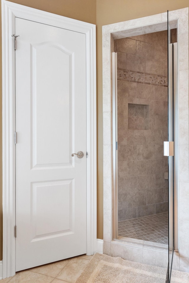 bathroom with walk in shower and tile patterned floors