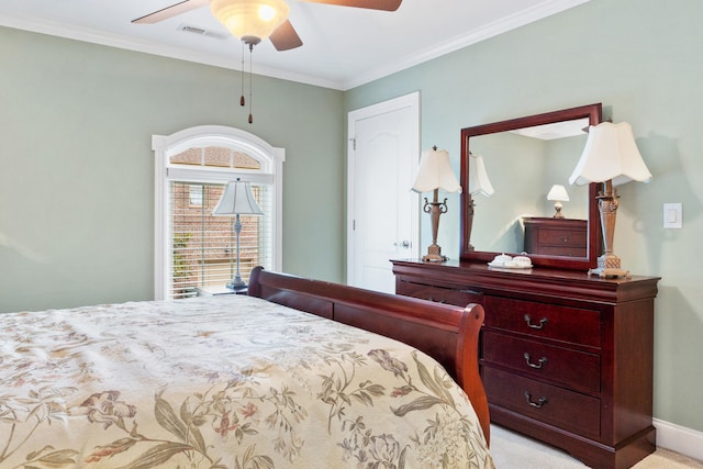 carpeted bedroom with ceiling fan and crown molding