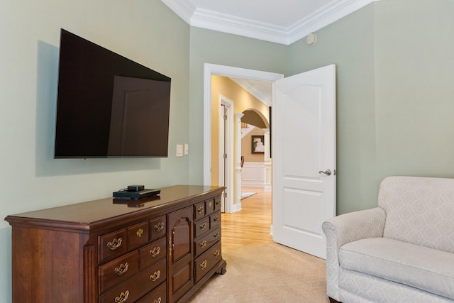 living area with light colored carpet and crown molding