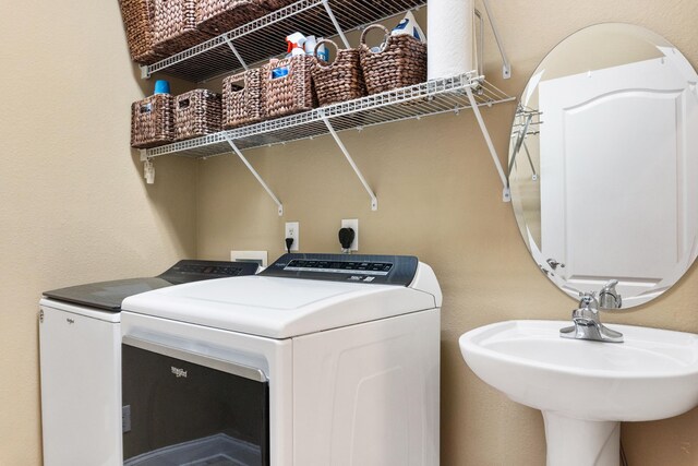 laundry room featuring sink and washer and dryer