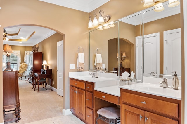 bathroom featuring ornamental molding, vanity, and ceiling fan