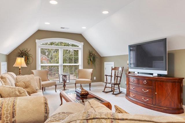 living room featuring light carpet and vaulted ceiling