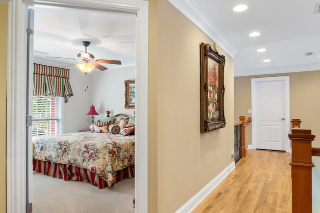 bedroom featuring ceiling fan, light hardwood / wood-style flooring, and crown molding