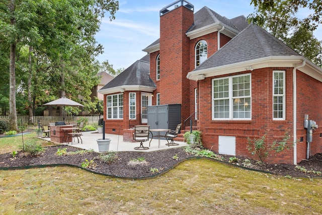 back of house with a lawn and a patio area