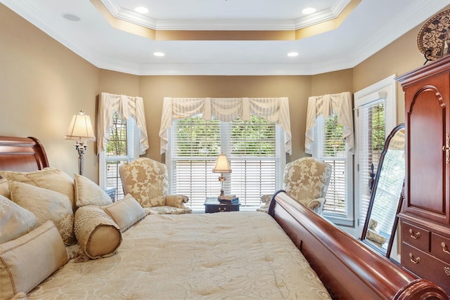 bedroom featuring multiple windows, crown molding, a tray ceiling, and access to exterior