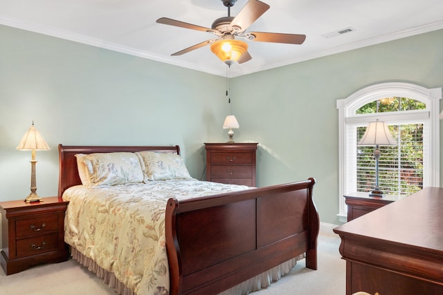 bedroom featuring ornamental molding, ceiling fan, and light colored carpet