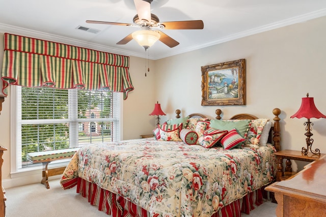 bedroom featuring ceiling fan, crown molding, and carpet