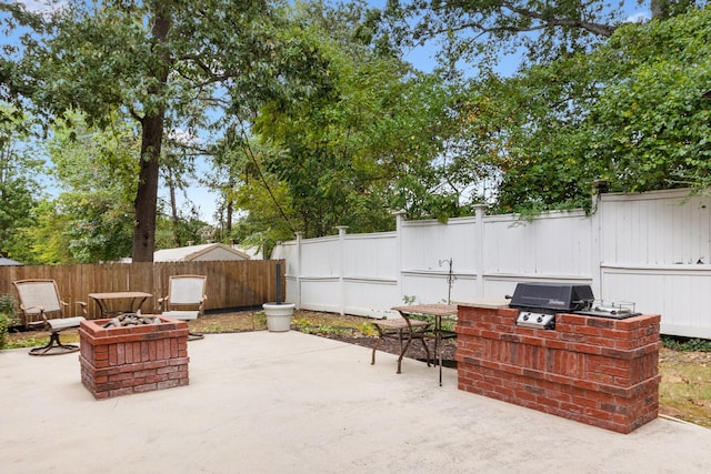 view of patio / terrace featuring a grill and an outdoor fire pit