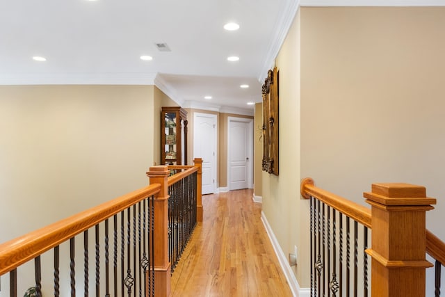 hall featuring crown molding and light hardwood / wood-style flooring