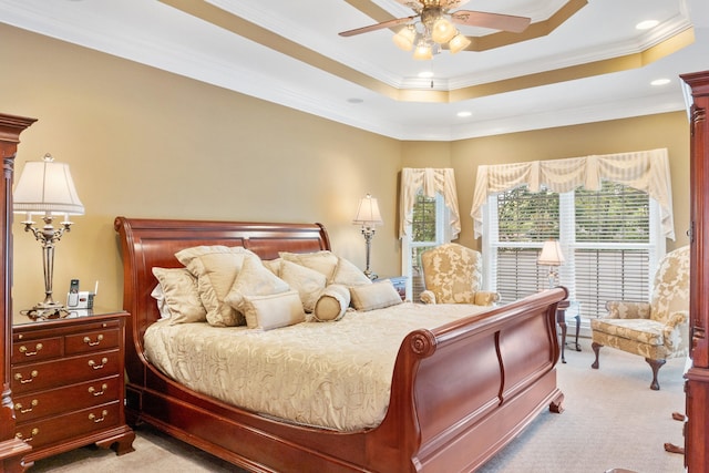 bedroom featuring light carpet, ceiling fan, a raised ceiling, and crown molding