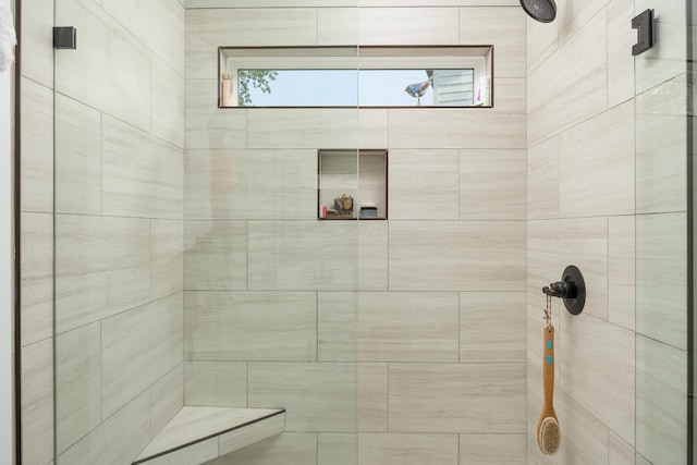 bathroom featuring plenty of natural light and a tile shower