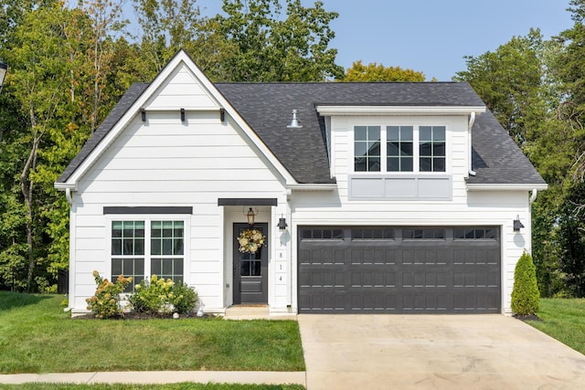 view of front of property featuring a garage and a front yard