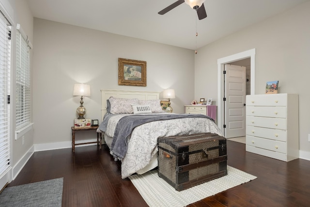 bedroom with dark hardwood / wood-style flooring and ceiling fan