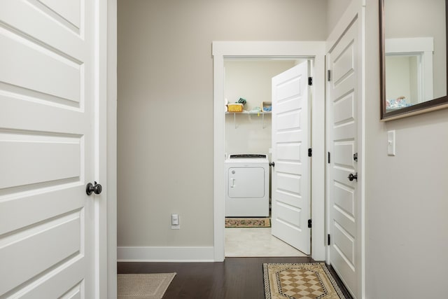 hall featuring hardwood / wood-style flooring and washer / dryer