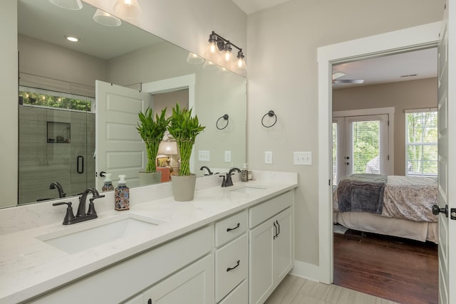 bathroom featuring hardwood / wood-style flooring, vanity, and an enclosed shower