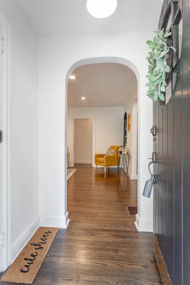 hallway with dark hardwood / wood-style floors