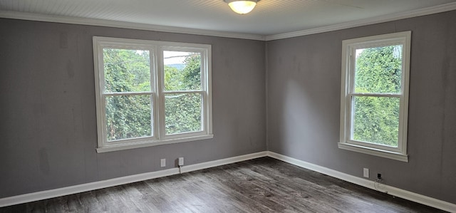 spare room with ornamental molding and dark hardwood / wood-style floors