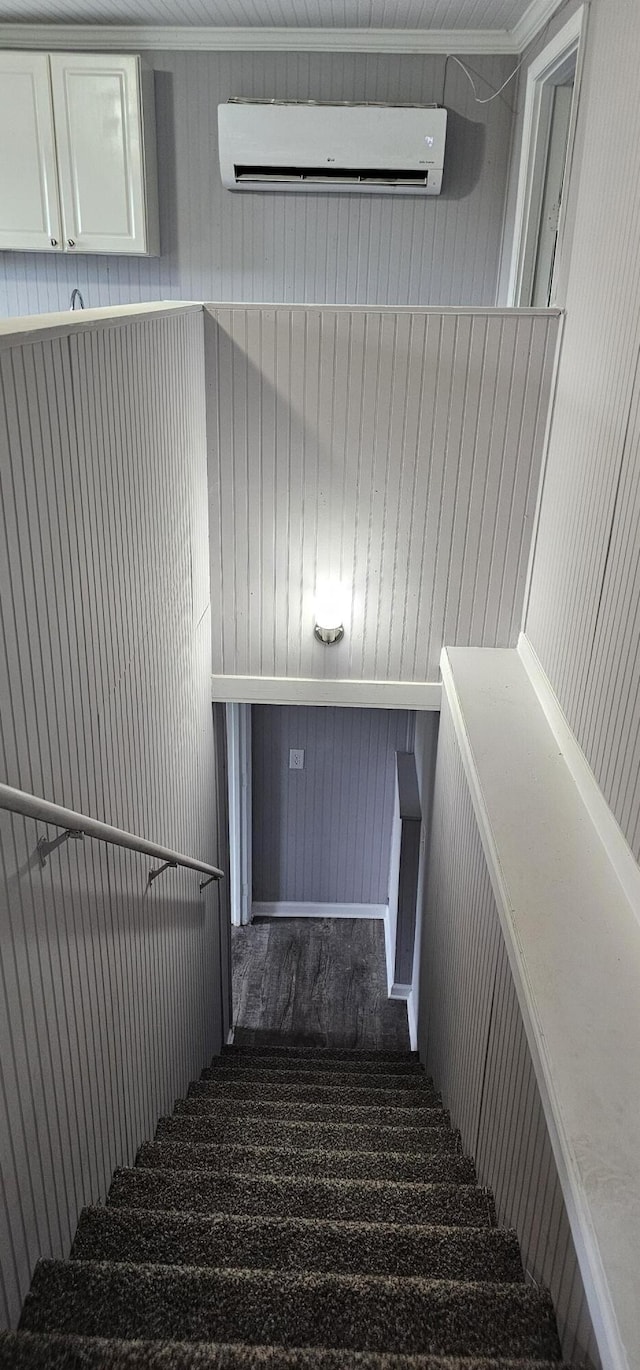 stairway featuring an AC wall unit, wooden walls, and carpet flooring