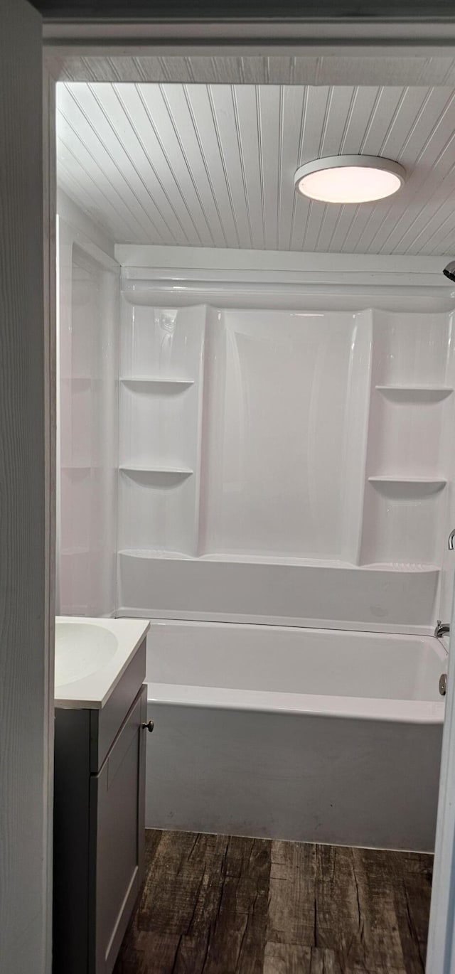 bathroom featuring bathtub / shower combination, hardwood / wood-style floors, and vanity