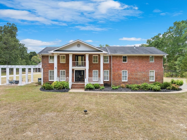 greek revival inspired property with a pergola, a porch, and a front lawn