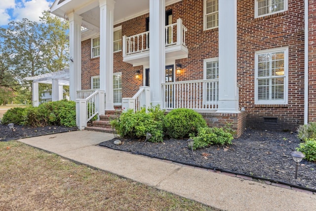 doorway to property with a pergola