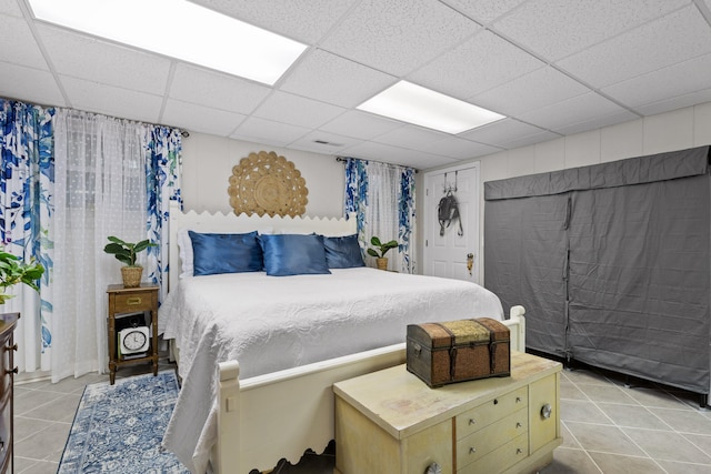 tiled bedroom with a drop ceiling