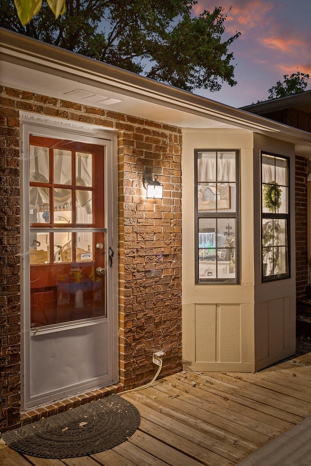 exterior entry at dusk with a deck