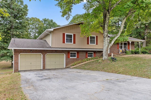 tri-level home featuring a garage and a front lawn