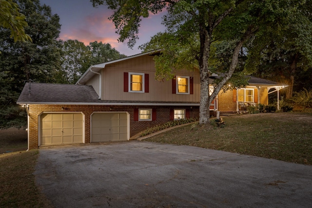 split level home with a lawn and a garage