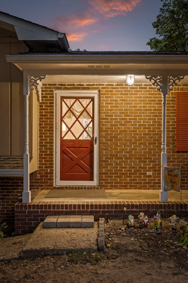 view of exterior entry at dusk