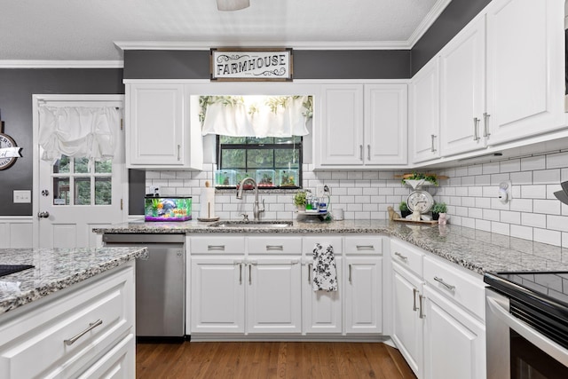 kitchen featuring wood-type flooring, dishwasher, sink, white cabinets, and ornamental molding