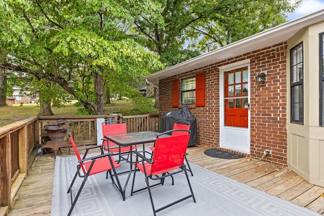 wooden deck featuring area for grilling