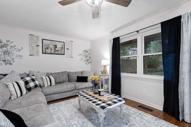 living room featuring ceiling fan, ornamental molding, and hardwood / wood-style floors