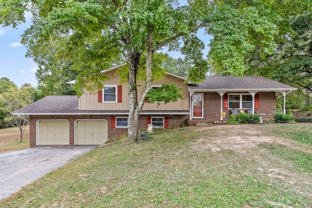 tri-level home featuring a garage and a front yard