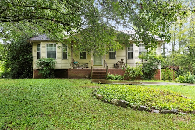 obstructed view of property with a front lawn