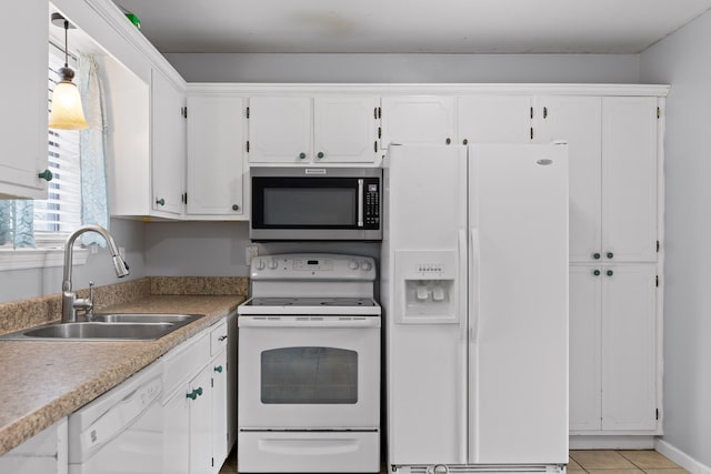 kitchen featuring white appliances, white cabinetry, sink, and light tile patterned flooring