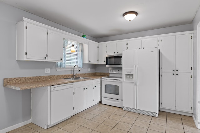 kitchen with white cabinets, white appliances, light tile patterned floors, and sink