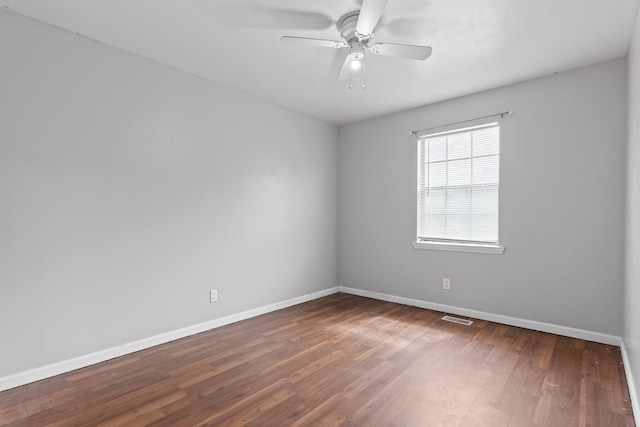 unfurnished room with ceiling fan and dark hardwood / wood-style flooring