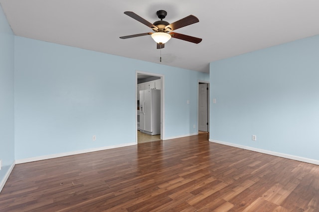 spare room with ceiling fan and dark hardwood / wood-style flooring