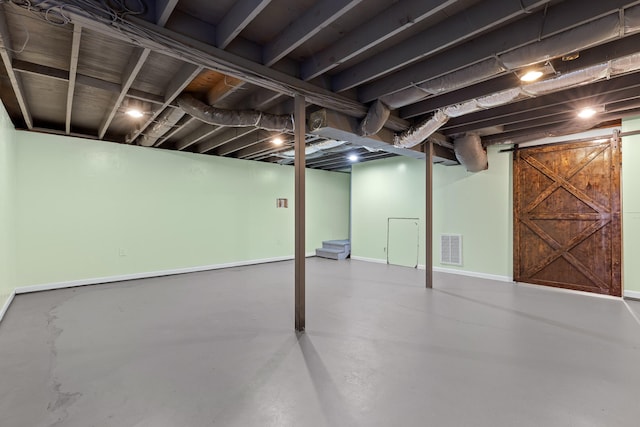 basement featuring a barn door