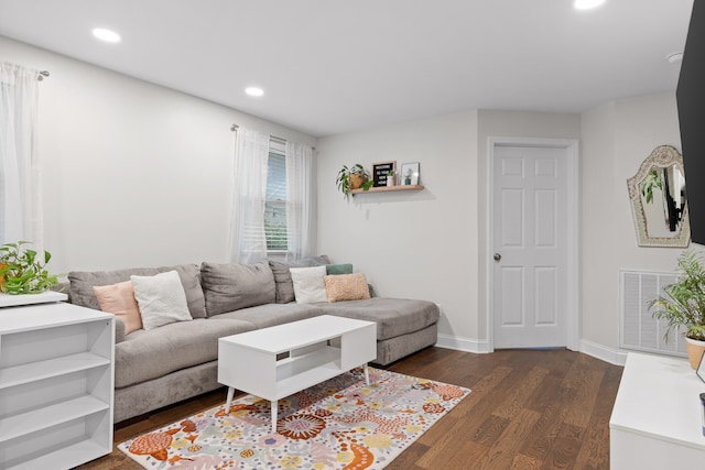 living room with dark hardwood / wood-style flooring