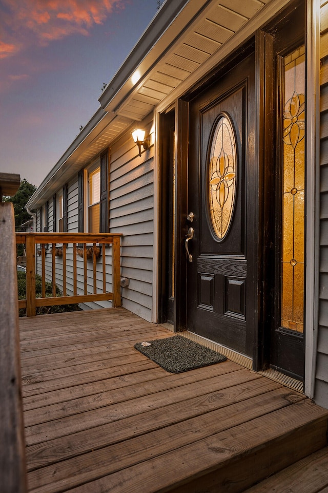 exterior entry at dusk with a deck