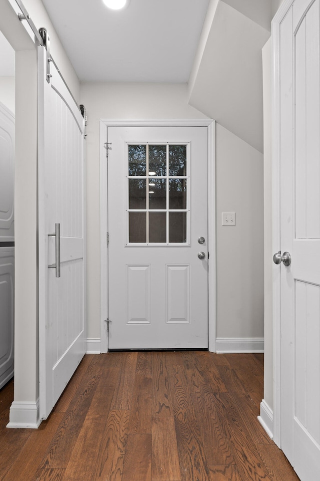 entryway featuring a barn door and dark hardwood / wood-style flooring