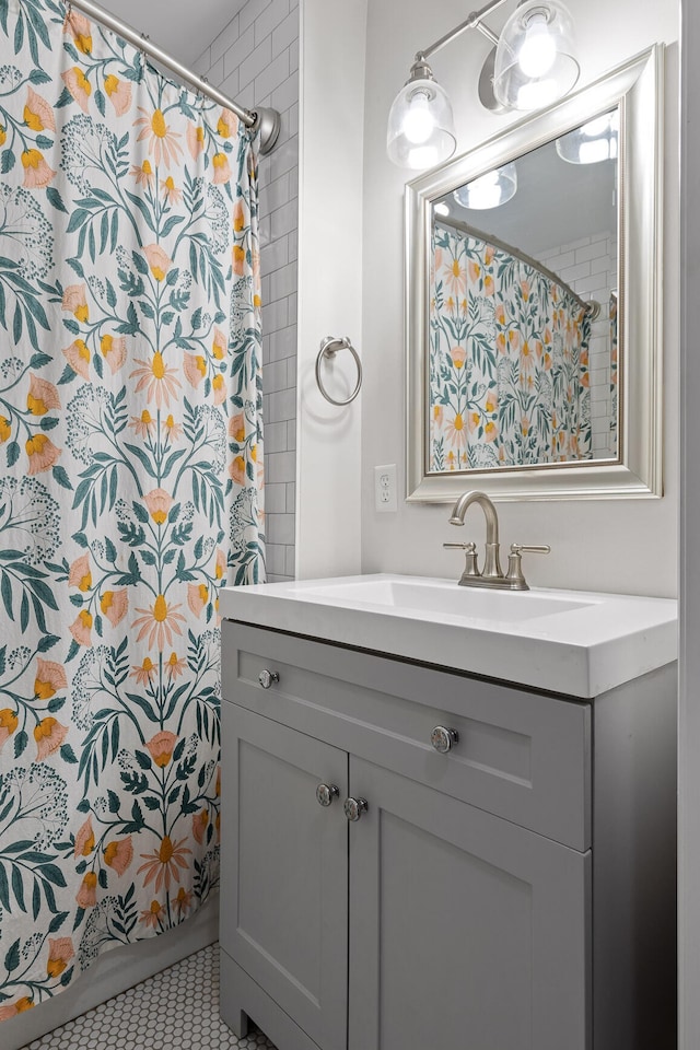 bathroom featuring a shower with curtain, vanity, and tile patterned flooring