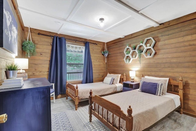 bedroom with wood walls, coffered ceiling, and hardwood / wood-style flooring